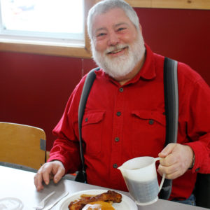 A man enjoys a pancake breakfast at last years event