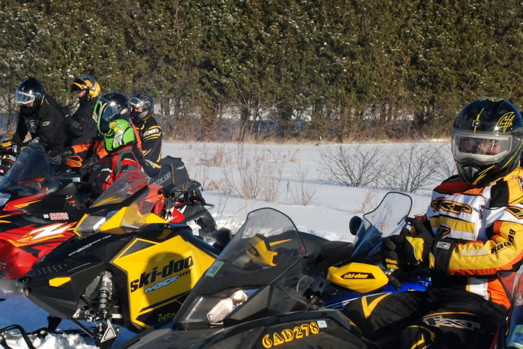 A line of snowmobiles waiting to go